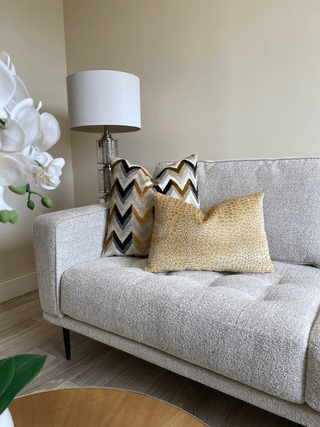 gold mosaic on couch with herringbone